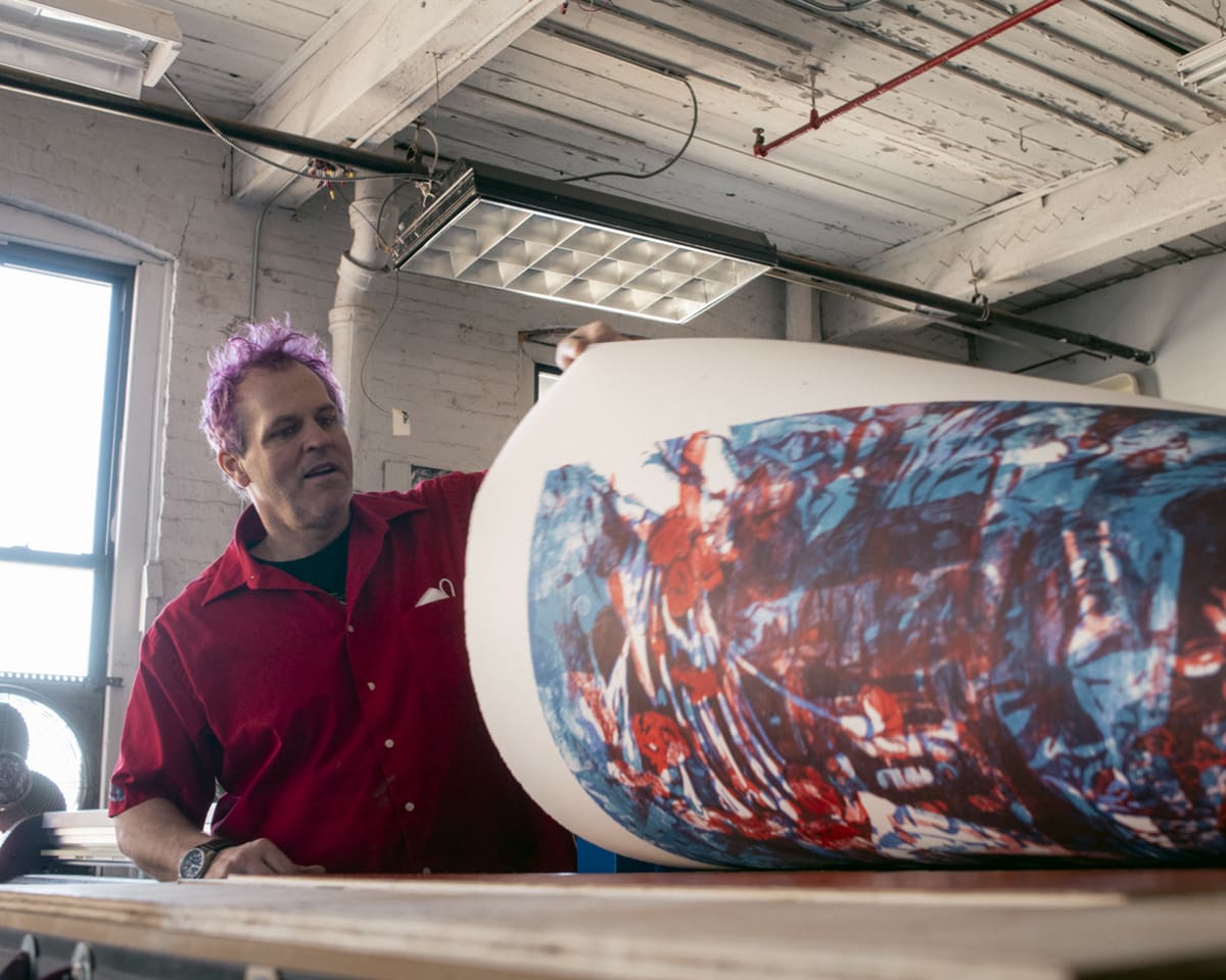 Artist Rob Swainston carving a block