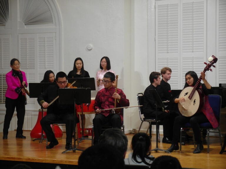 several people play Chinese instruments on stage