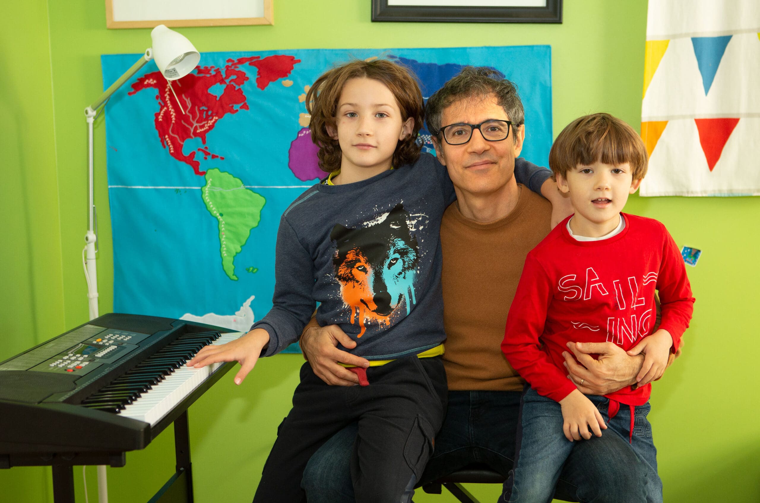 The author with his two sons in front of their keyboard.