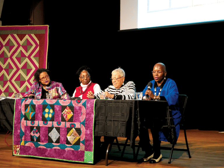 Four women sit at table
