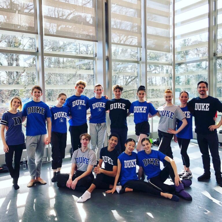 a group of ballet dancers pos for a photo