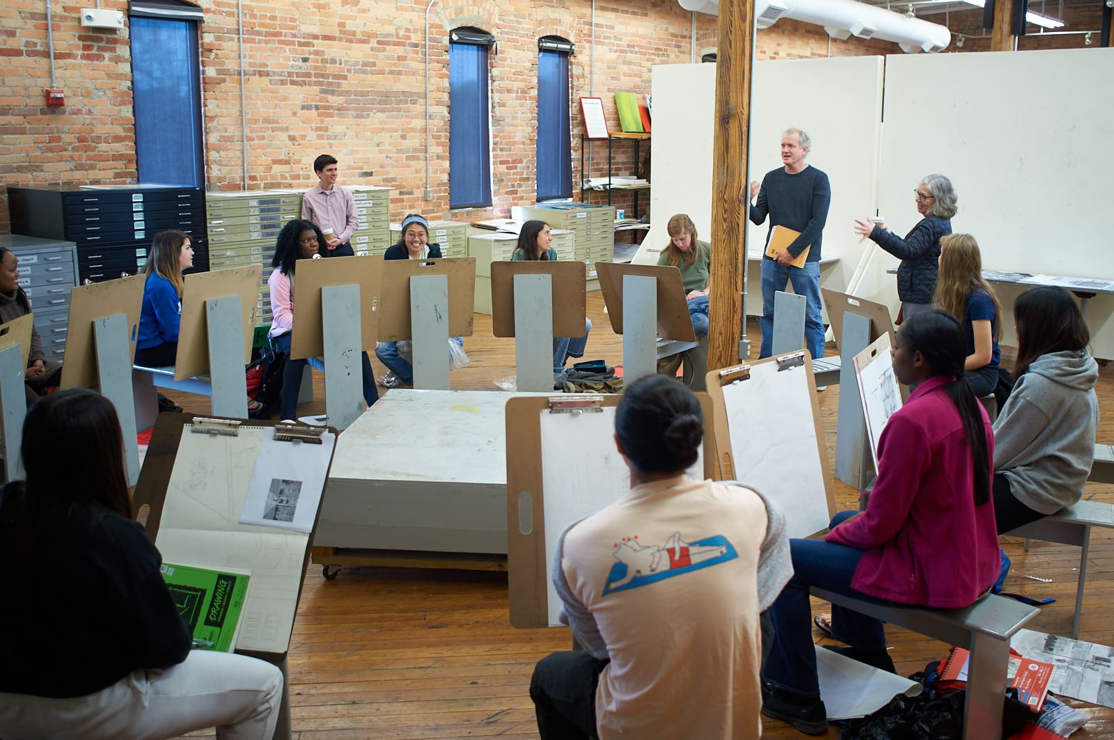 Maira Kalman speaks to drawing students as Bill Fick looks on.