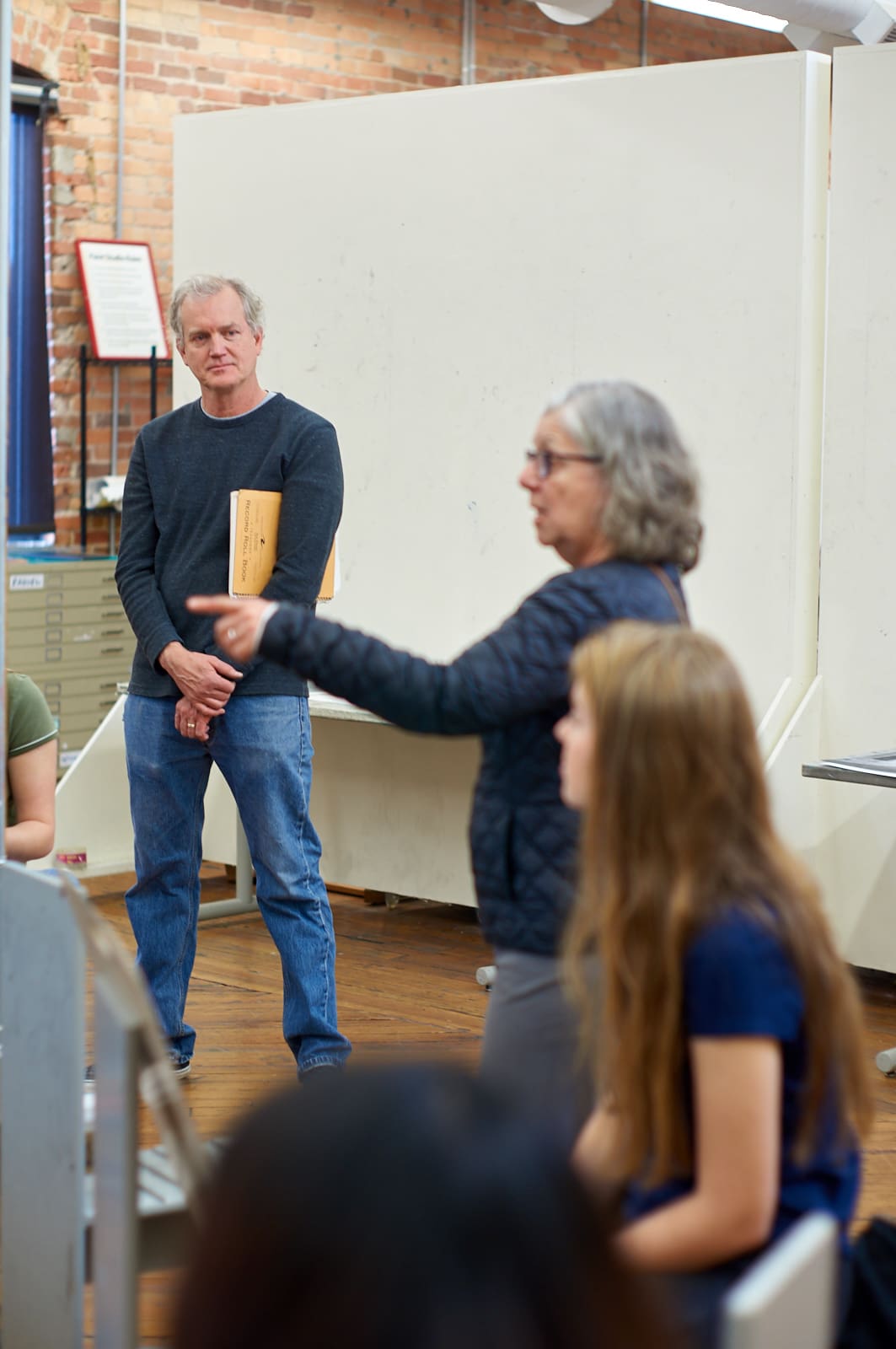 Bill Fick looks on as Kalman talks to the students