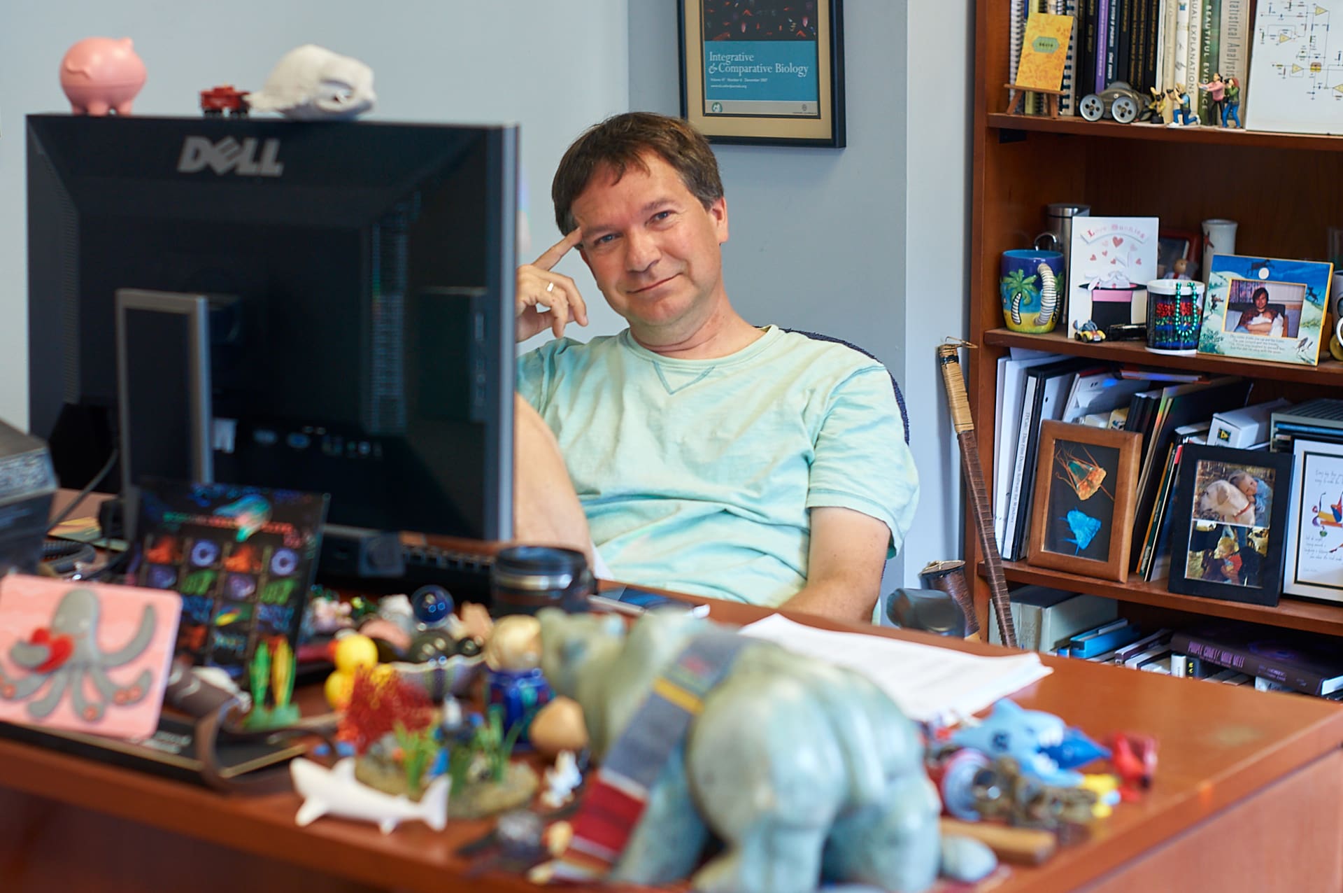 Sonke Johnsen in his office, with lots of silly toys on his desk.