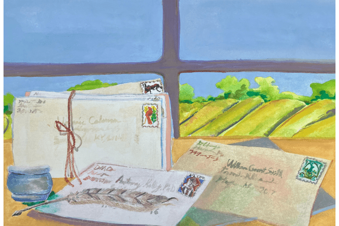 Addressed letters on a desk in front of a window overlooking green hills