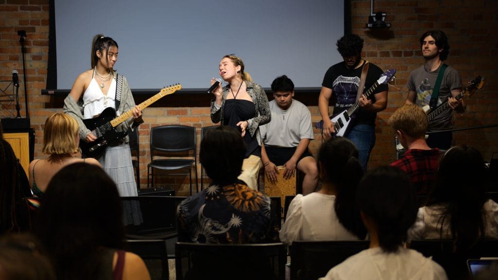 A band of young adult students playing insturments