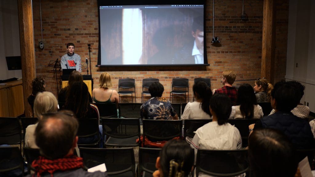 A young adult student giving a presentation