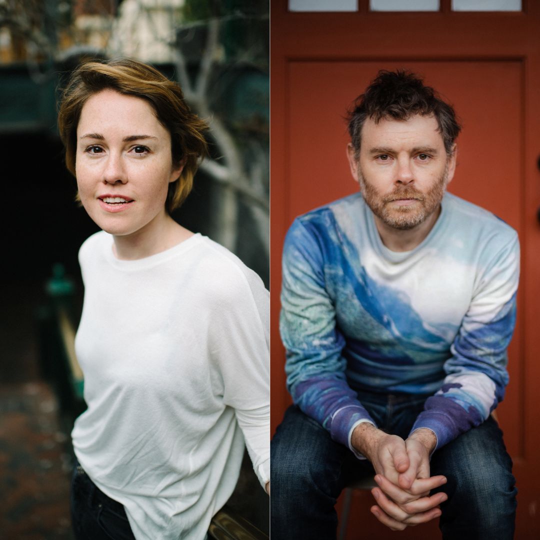 A woman with short brown hair and a white top looks into the camera. A man with a stubbly beard and a variegated blue sweater faces head-on.