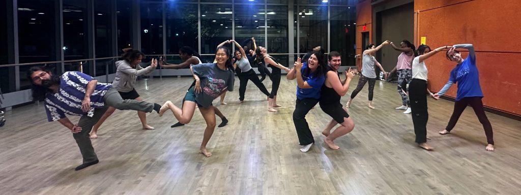 Young adult students participating in a dance workshop in a dance studio